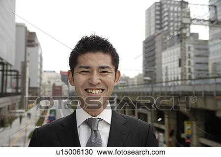 Stock Image - Close-up of a smiling businessman. Fotosearch