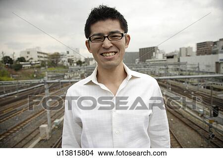 Close-up of a smiling young man View Large Photo Image Picture - Close-up of a smiling young man. Fotosearch