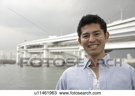 Stock Image - Close-up of a smiling young man. Fotosearch