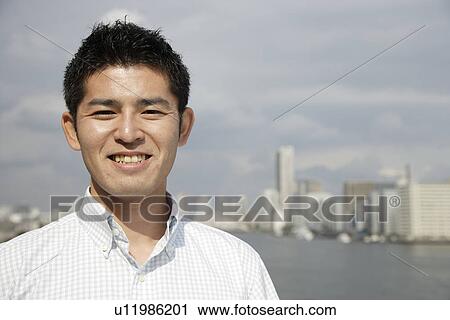 Stock Image - Close-up of a smiling young man. Fotosearch