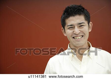 Stock Image - Close-up of a young man smiling. Fotosearch