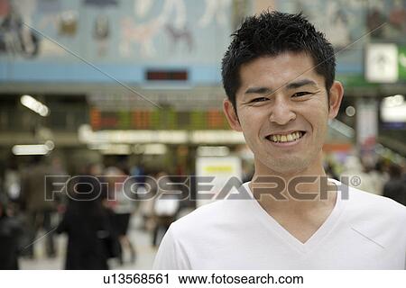 Close-up of a young man smiling View Large Photo Image Stock Image - Close-up of a young man smiling. Fotosearch