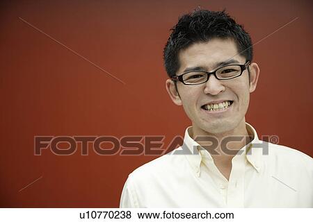 Stock Photo - Close-up of a young man smiling. Fotosearch