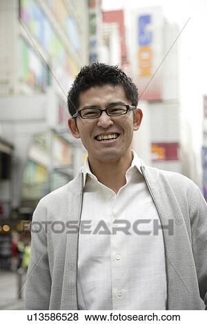 Stock Photo - Close-up of a young man wearing glasses. Fotosearch
