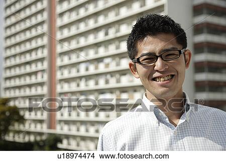 Close-up of a young man wearing spectacles View Large Photo Image Picture - Close-up of a young man wearing spectacles. Fotosearch