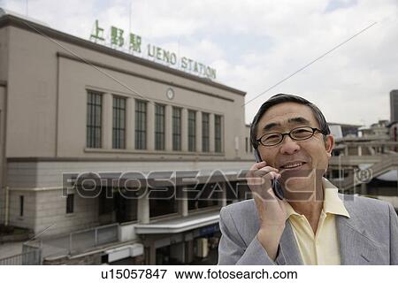 Stock Photo - Close-up of a senior man using mobile phone. Fotosearch