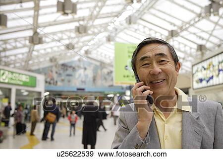 Stock Photo - Close-up of a senior man using mobile phone. Fotosearch