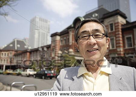Stock Photo - Close-up of a smiling senior man wearing glasses. Fotosearch
