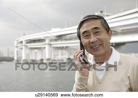 Stock Photo - Portrait of a senior man using cellphone. Fotosearch