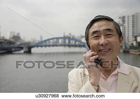 Portrait of a senior man using mobile phone View Large Photo Image Stock Photo - Portrait of a senior man using mobile phone. Fotosearch