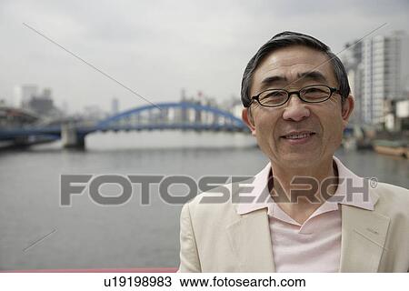 Stock Image - Portrait of a senior man wearing spectacles. Fotosearch