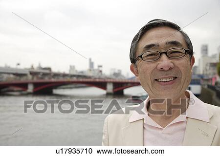 Portrait of a smiling senior man wearing glasses View Large Photo Image Stock Image - Portrait of a smiling senior man wearing glasses. Fotosearch