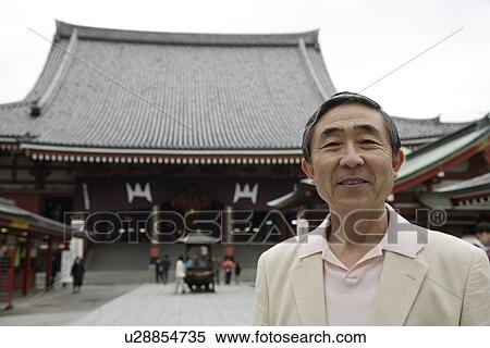 Stock Photography - Portrait of a smiling senior man standing. Fotosearch