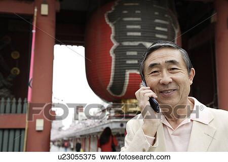 Portrait of a smiling senior man using mobile phone View Large Photo Image Stock Photography - Portrait of a smiling senior man using mobile phone. Fotosearch