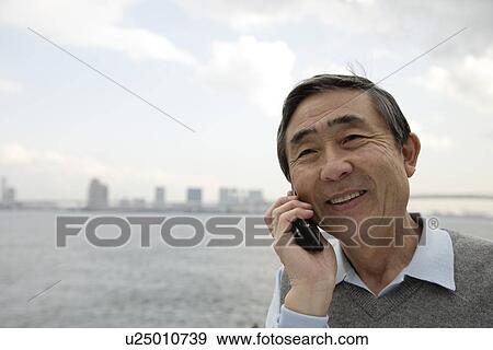 Stock Photo - View of a businessman using cellphone. Fotosearch