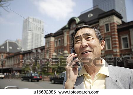 View of a businessman using cellphone View Large Photo Image Stock Photography - View of a businessman using cellphone. Fotosearch