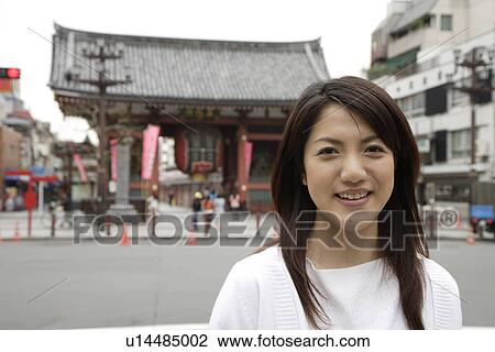 Stock Image - Close-up of a smiling young woman. Fotosearch