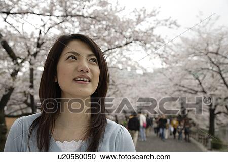 Close-up of a smiling young woman View Large Photo Image Stock Image - Close-up of a smiling young woman. Fotosearch