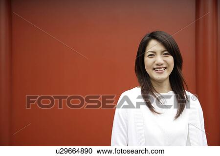 Stock Image - Close-up of a smiling young woman portrait. Fotosearch