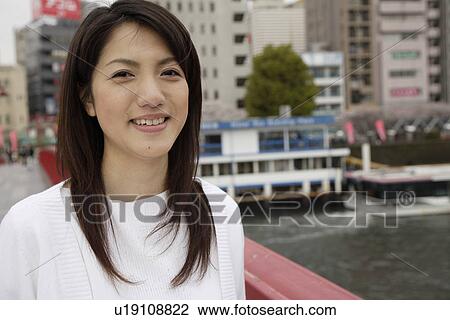 Stock Image - Close-up of a young woman smiling. Fotosearch