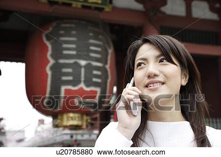 Close-up of a young woman using mobile phone View Large Photo Image Stock Image - Close-up of a young woman using mobile phone. Fotosearch