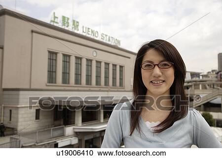 Close-up of a young woman wearing glasses View Large Photo Image Stock Image - Close-up of a young woman wearing glasses. Fotosearch