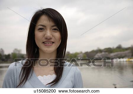 Stock Image - Portrait of a smiling young woman. Fotosearch