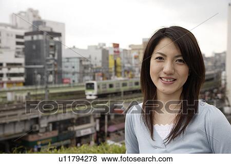 Stock Photo - Portrait of a smiling young woman. Fotosearch