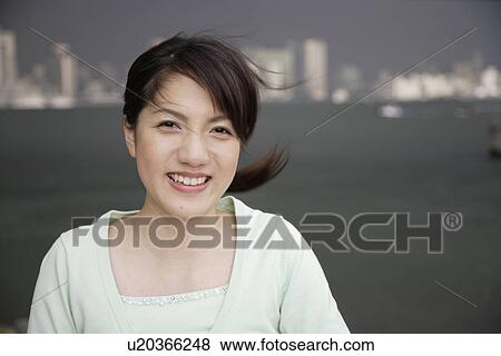 Stock Photo - Portrait of a smiling young woman. Fotosearch