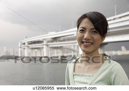 Stock Photography - Portrait of a smiling young woman. Fotosearch