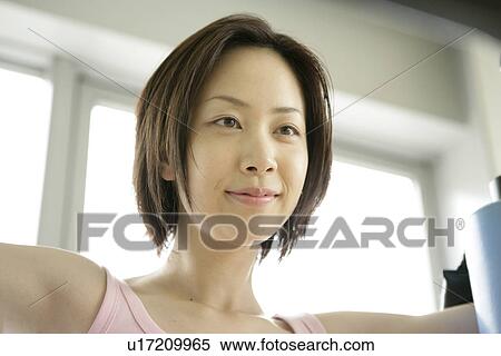 Close up of a young woman smiling in front of the camera View Large Photo Image Stock Photography - Close up of a young woman smiling in front of the camera. Fotosearch