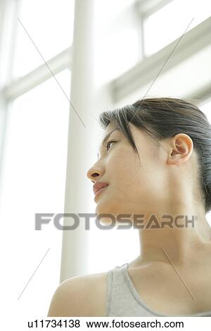 Low angle view of a young woman wearing workout suit View Large Photo Image Stock Photo - Low angle view of a young woman wearing workout suit. Fotosearch