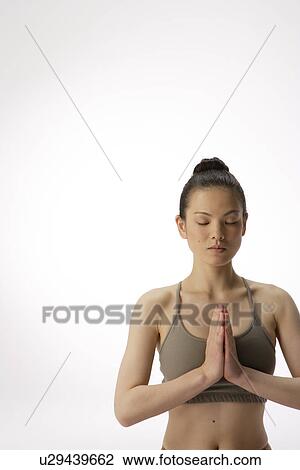 Close-up of a young woman meditating View Large Photo Image Stock Image - Close-up of a young woman meditating. Fotosearch