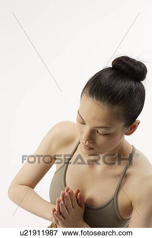 Stock Photo - High angle view of a young woman in lotus position. Fotosearch