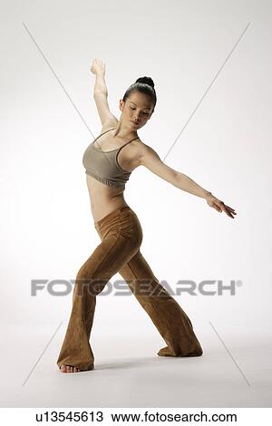 Stock Image - View of a young woman stretching her body. Fotosearch