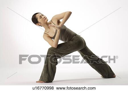 Stock Photo - View of a young woman stretching her body. Fotosearch