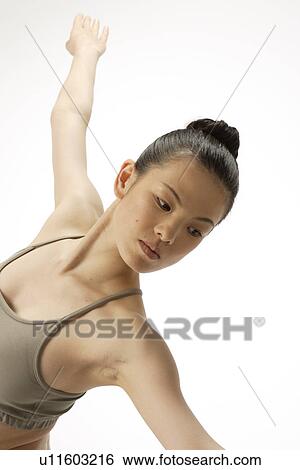 Stock Photograph - View of a young woman stretching her body. Fotosearch