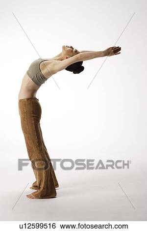 Stock Photograph - View of a young woman stretching her body. Fotosearch