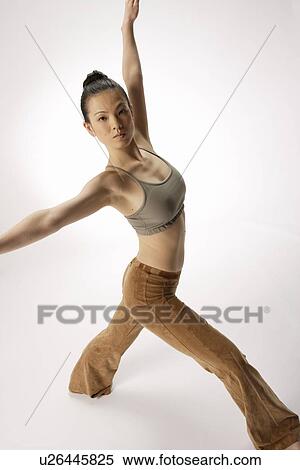 View of a young woman stretching her body View Large Photo Image Stock Photography - View of a young woman stretching her body. Fotosearch