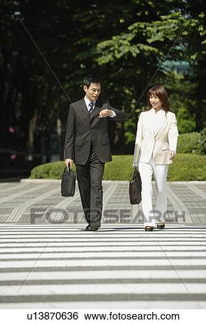 Stock Photograph - Front view of two professionals walking. Fotosearch