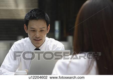 Stock Image - Man working on a laptop. Fotosearch