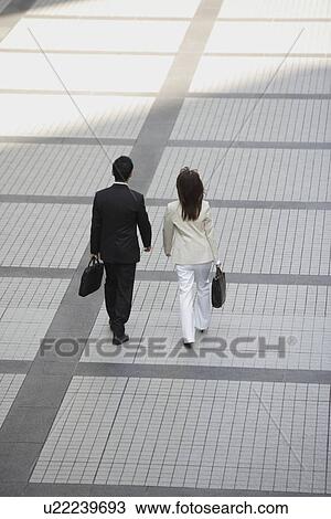 Rear view of professionals walking during the day View Large Photo Image Stock Image - Rear view of professionals walking during the day. Fotosearch