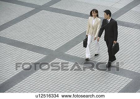 Side view of professionals walking View Large Photo Image Picture - Side view of professionals walking. Fotosearch