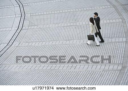 Side view of professionals walking View Large Photo Image Picture - Side view of professionals walking. Fotosearch