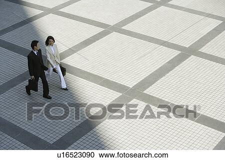 Stock Image - Side view of professionals walking. Fotosearch