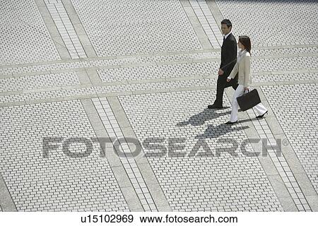 Stock Photo - Side view of professionals walking. Fotosearch