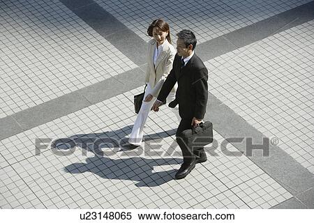 Stock Photography - Side view of professionals walking. Fotosearch