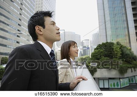 Stock Image - Side view of two professionals. Fotosearch