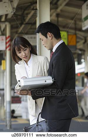 Stock Image - side view of two professionals. Fotosearch