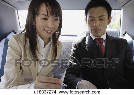 Two business people in a car View Large Photo Image Picture - Two business people in a car. Fotosearch